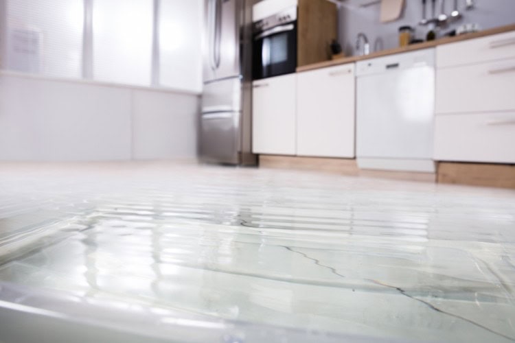 Kitchen water flooded on floor due to the blocked drain